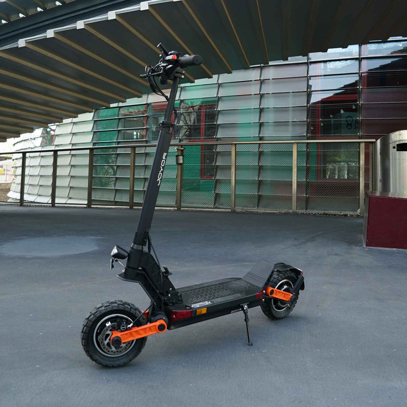 Load image into Gallery viewer, Joyor S10-S-Z electric scooter on city streets, combining sleek design with powerful performance for urban commuting and adventure.
